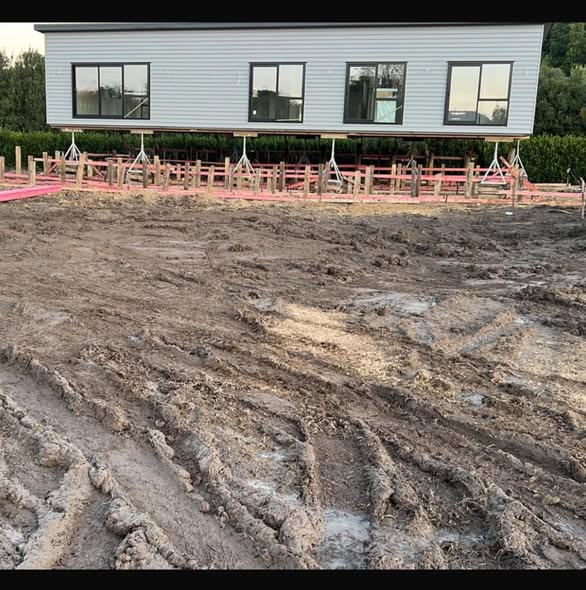 Drone aerial of Hamilton subdivision in framing stage with excavator and foundation pits