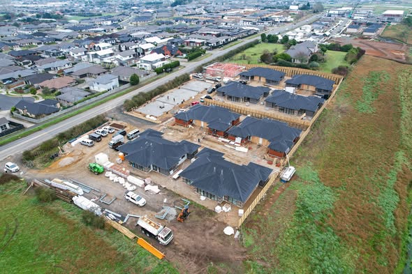 Aerial drone shot of an LTK Construction multi-unit subdivision with finished black-roofed townhouses, Hamilton